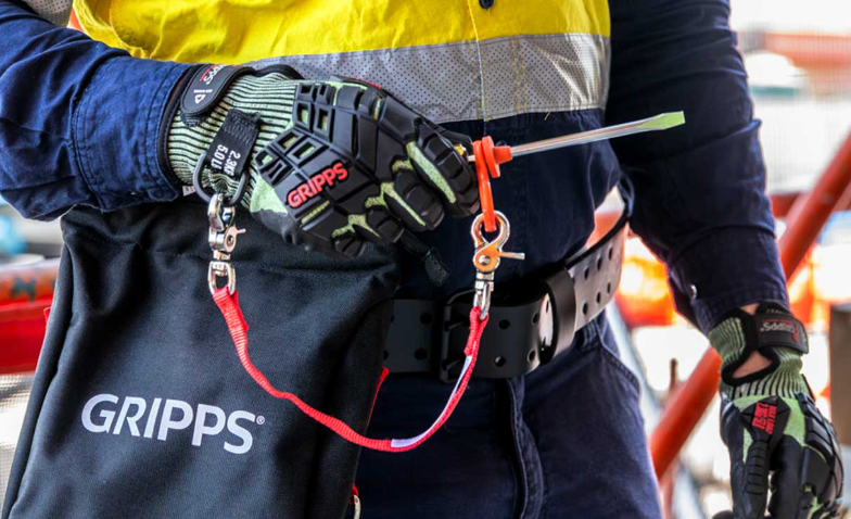 GRIPPS tool tethering glove and tethered screwdriver in use